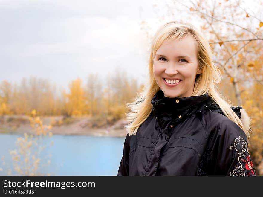 Beautiful blond woman near the lake