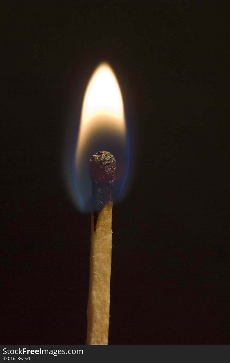 Burning match on the black background