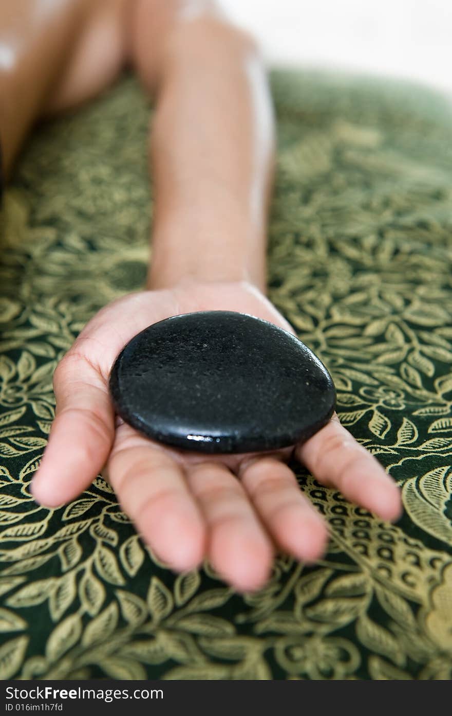 Photo of warm stone massage. Photo of warm stone massage