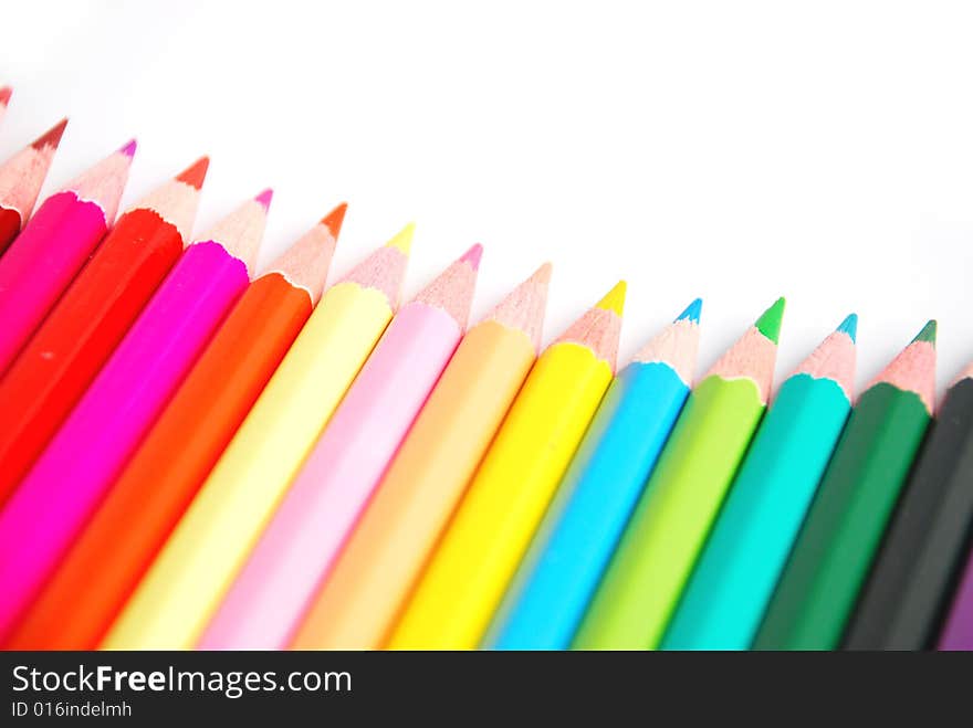 Assortment of coloured pencils with shadow on white background. Assortment of coloured pencils with shadow on white background