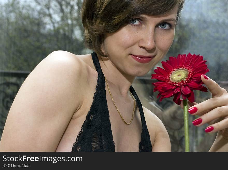 Pretty woman holdind a red flower