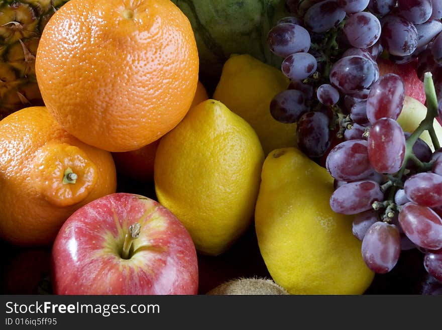 A heap of cut tropical fruits , very colorful image