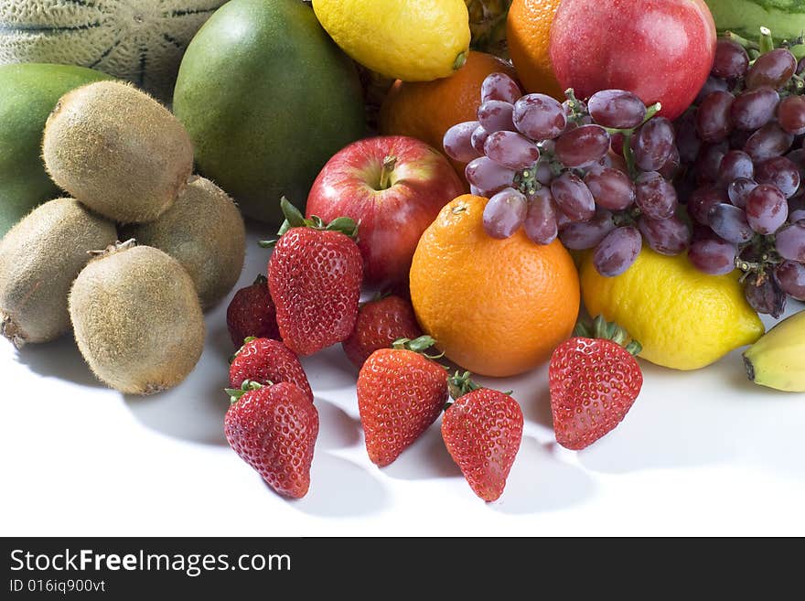 A heap of cut tropical fruits on a white background, very colorful image