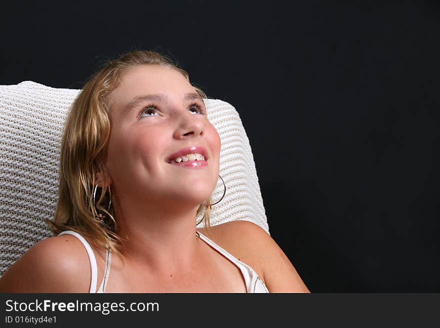 Teenage female mode sittingl on a white chair. Teenage female mode sittingl on a white chair