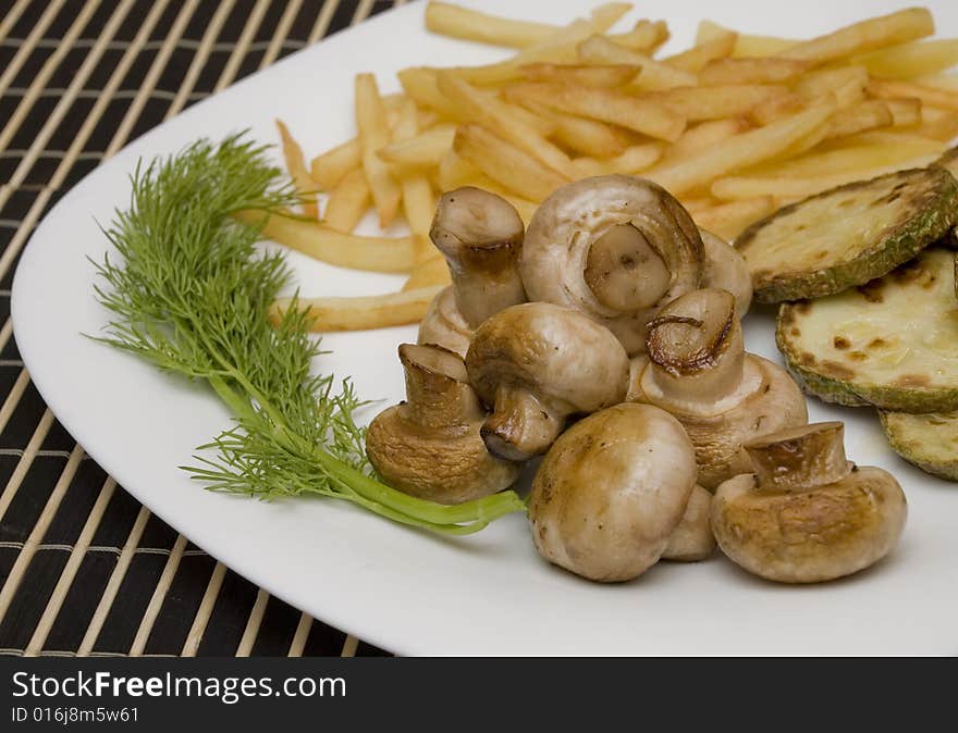 Tasty field mushrooms with a potato free and courgettes. Tasty field mushrooms with a potato free and courgettes