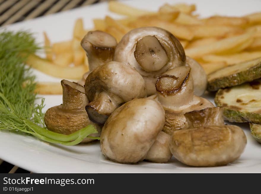 Tasty field mushrooms with a potato free, closeup. Tasty field mushrooms with a potato free, closeup