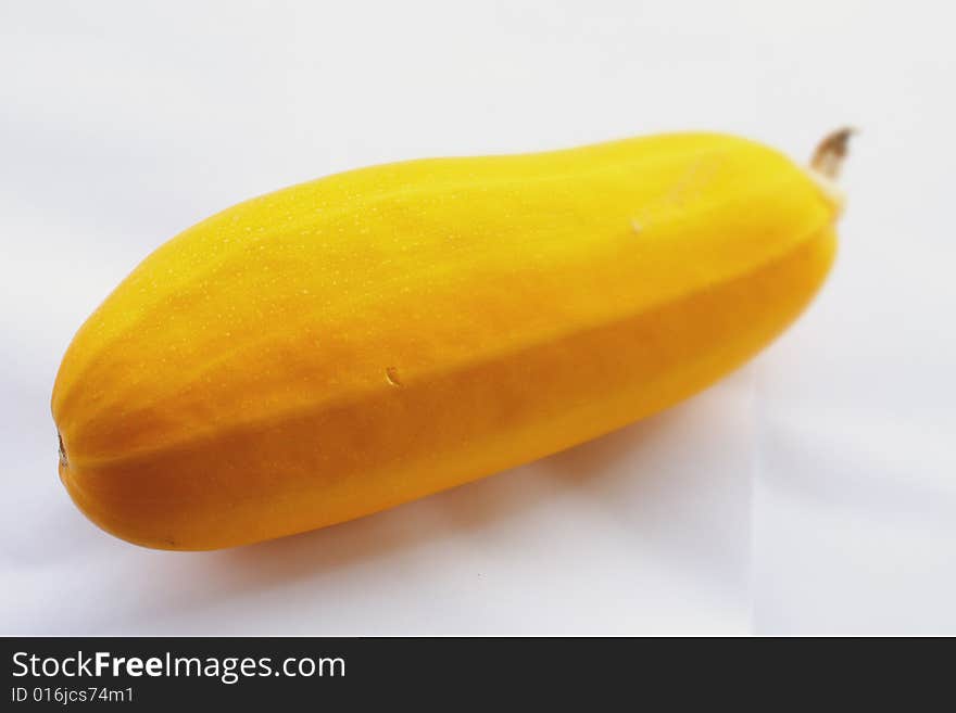 Yellow vegetable marrow on a white background small depth of sharpness