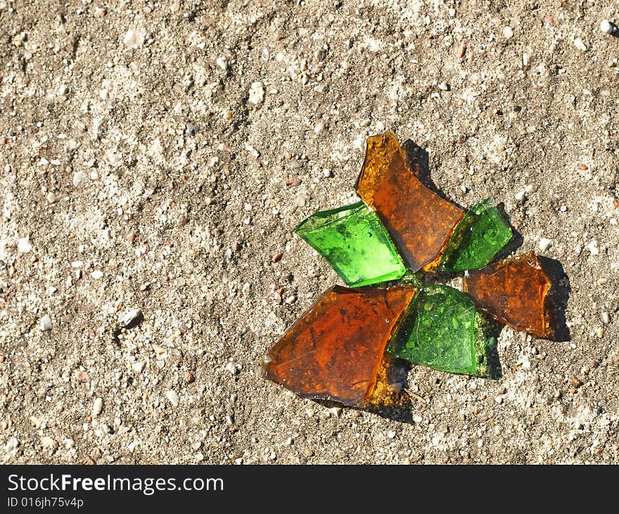 Orange And Green Glassy Chips Reminding Butterfly On Concrete