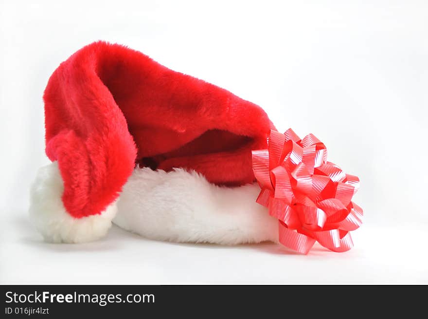 Santa's hat with a red ribbon on a white background