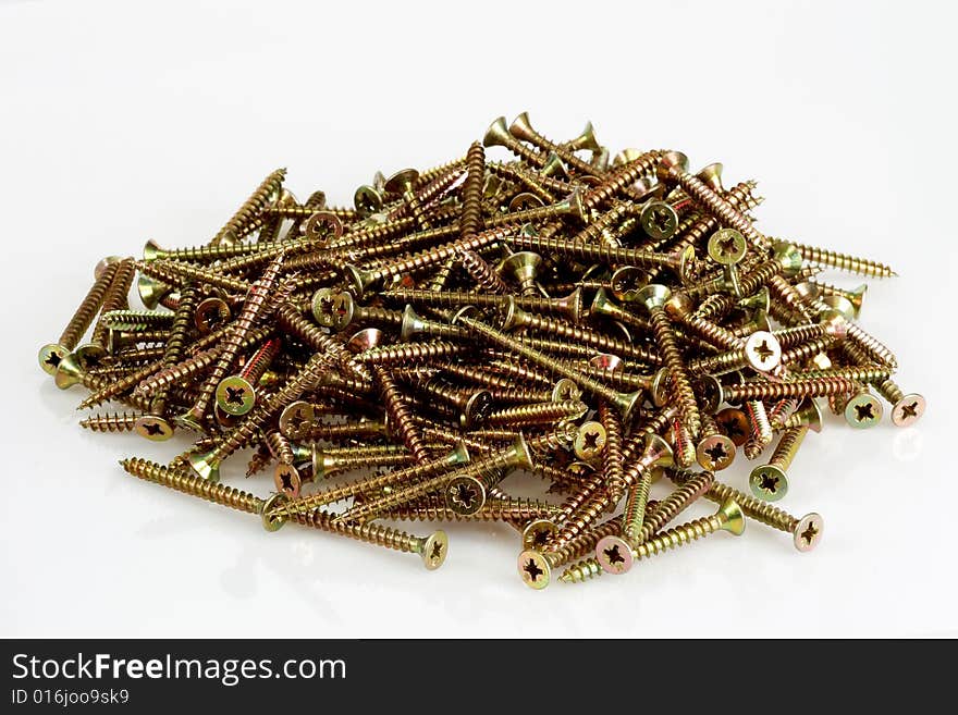 A pile screws on bright background. A pile screws on bright background