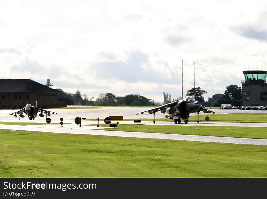 Twp RAF Harriers taxi to the active at RNAS Yeovilton. Twp RAF Harriers taxi to the active at RNAS Yeovilton