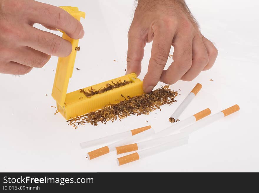 Hands of man making cigarettes