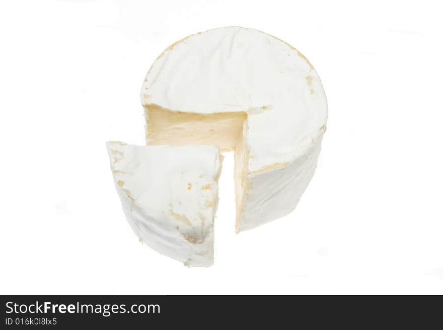 Round of soft cheese with wedge cut out. Round of soft cheese with wedge cut out