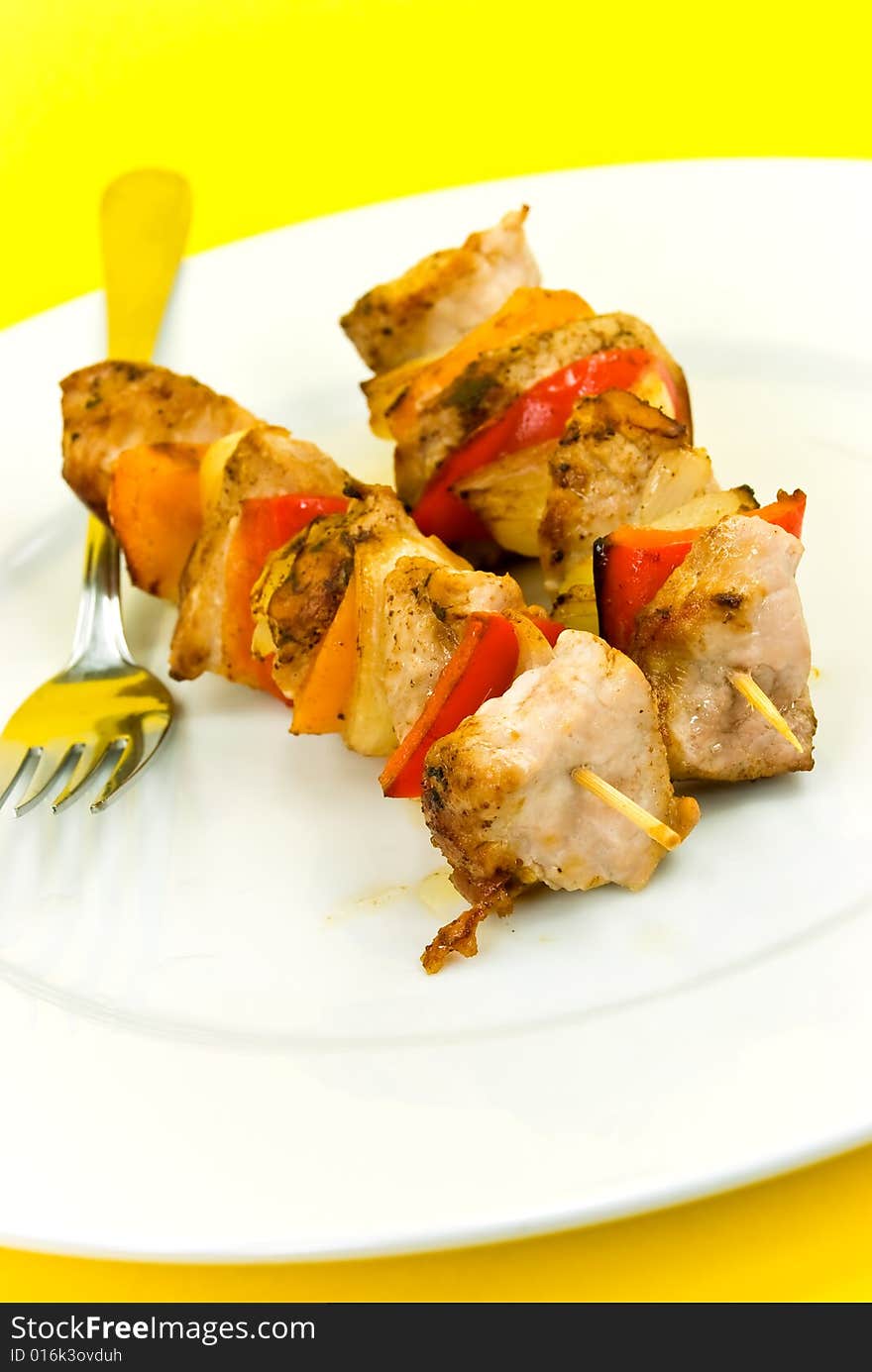 Two skewer with onion and vegetables.