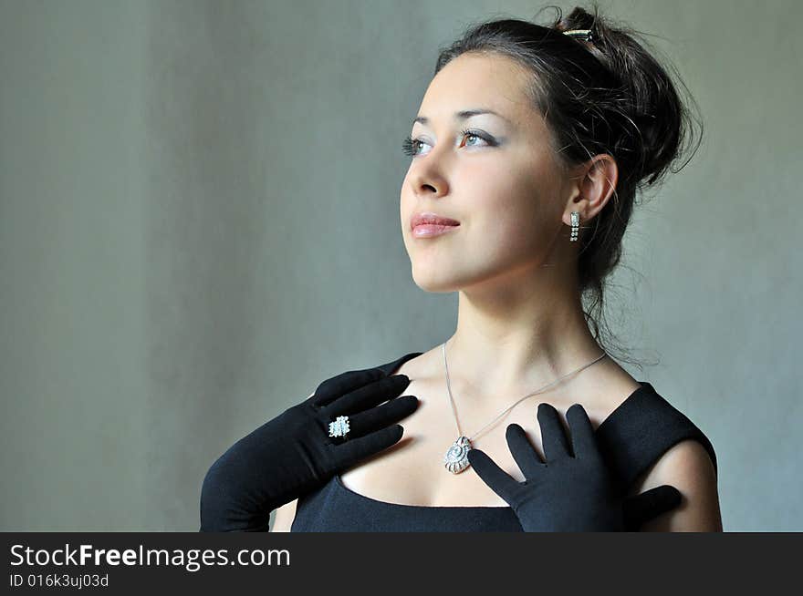 Beautiful model in a black dress with jewel. Beautiful model in a black dress with jewel