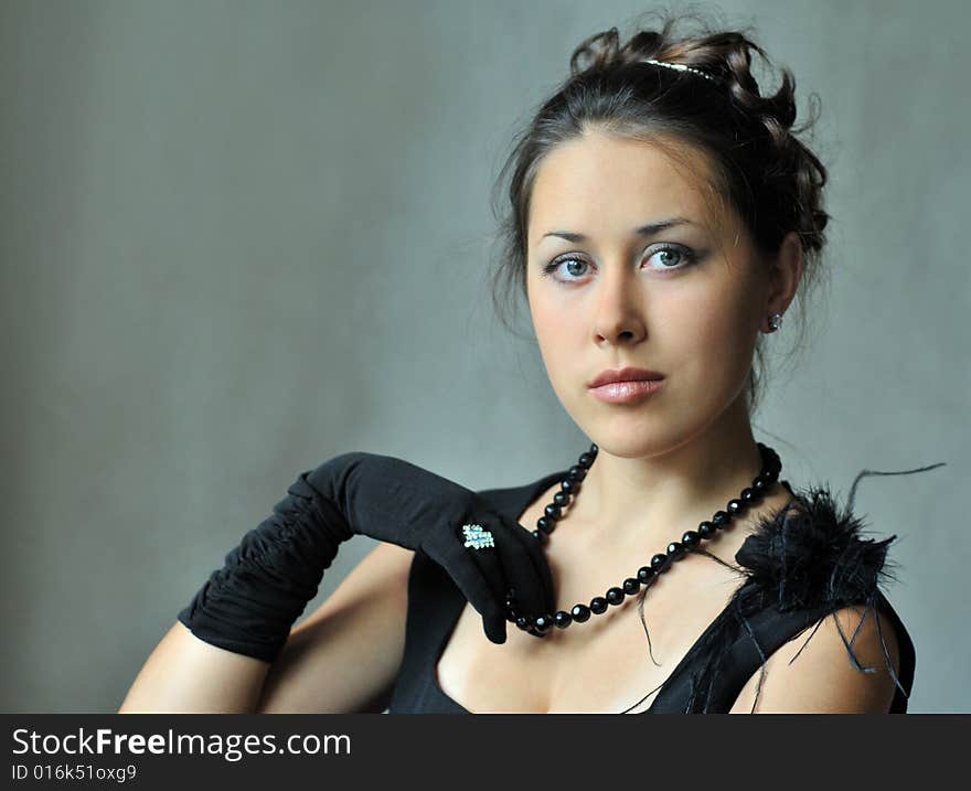 Beautiful model in a black dress with jewel. Beautiful model in a black dress with jewel