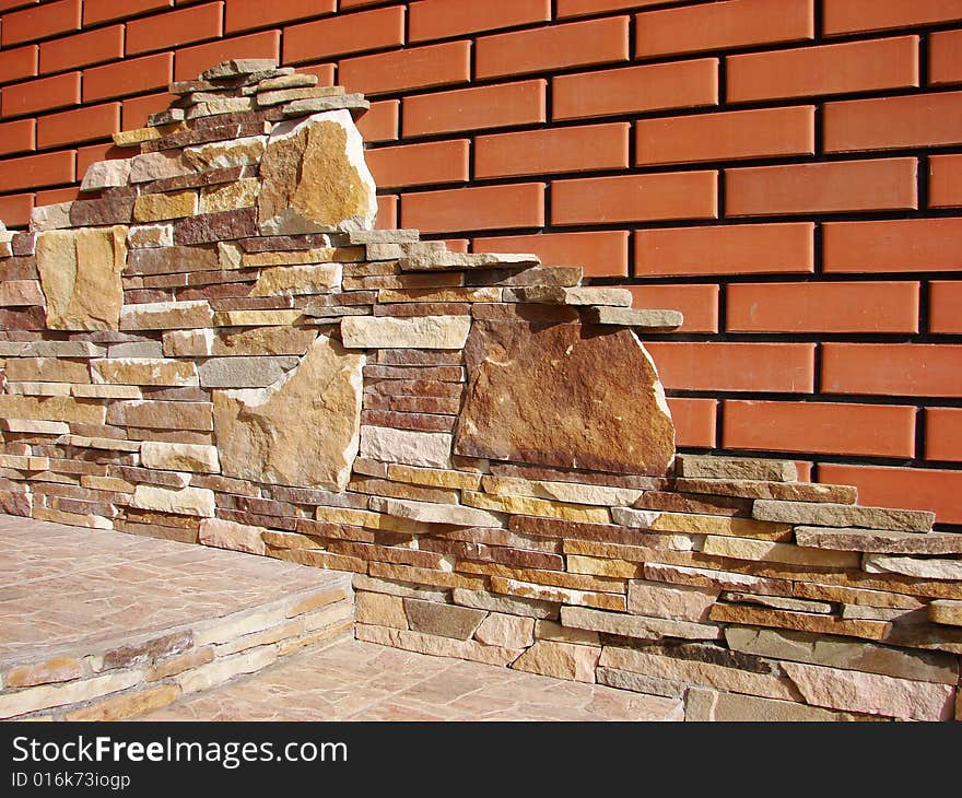 Irregular brick wall with various tint and forms of brick