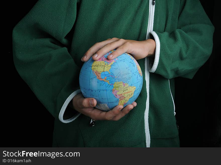 Close-up of Earth globe holded by a boy. Close-up of Earth globe holded by a boy