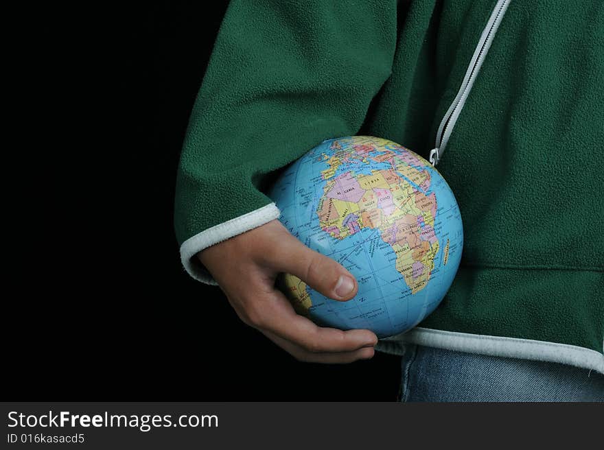 Close-up of Earth globe holded by a boy. Close-up of Earth globe holded by a boy