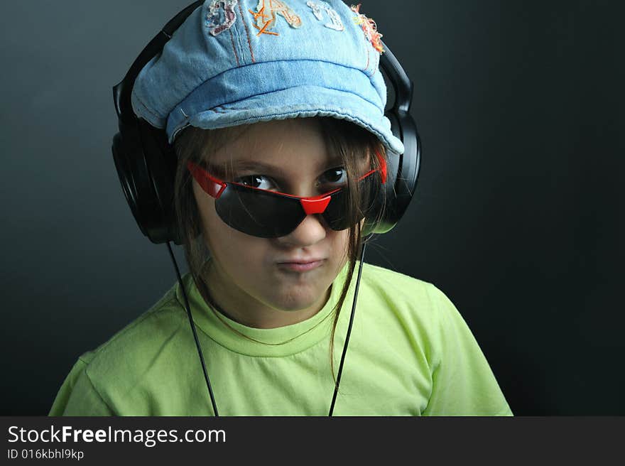 Portrait of a little girl with ear phones listening music