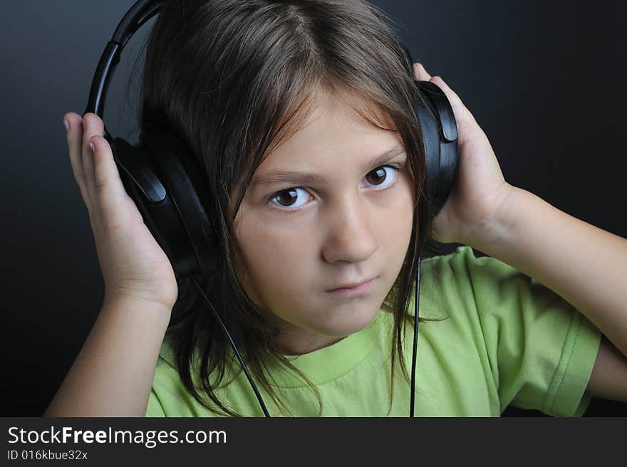 Portrait of a little girl with ear phones listening music. Portrait of a little girl with ear phones listening music