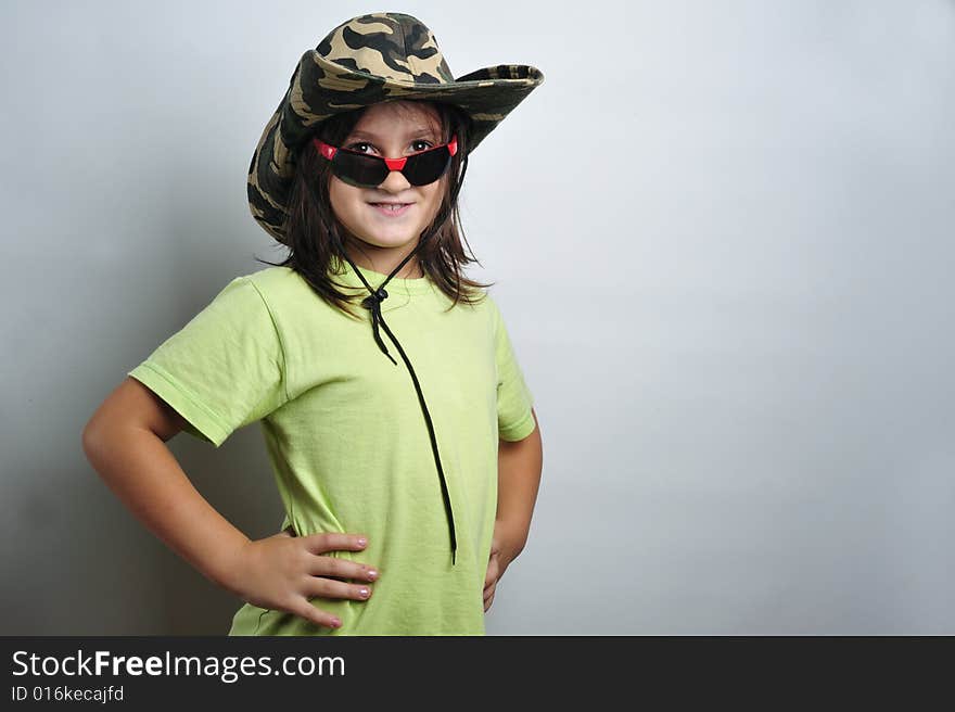 Portrait of a little girl with sunglasses and heat. Portrait of a little girl with sunglasses and heat