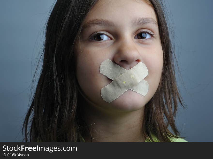 Portrait of a girl with bandaids over her lips. Portrait of a girl with bandaids over her lips