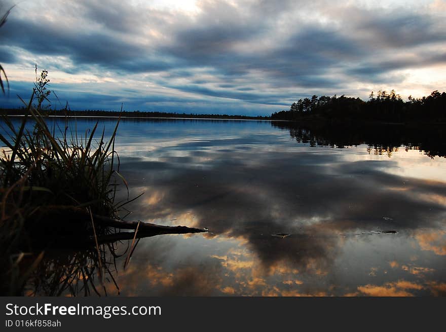 A calm lake and sky at dusk. A calm lake and sky at dusk.