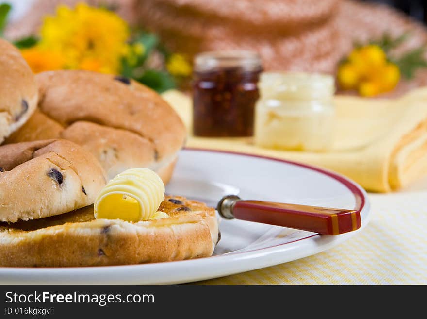 Delicious fresh tea cakes with butter on a plate