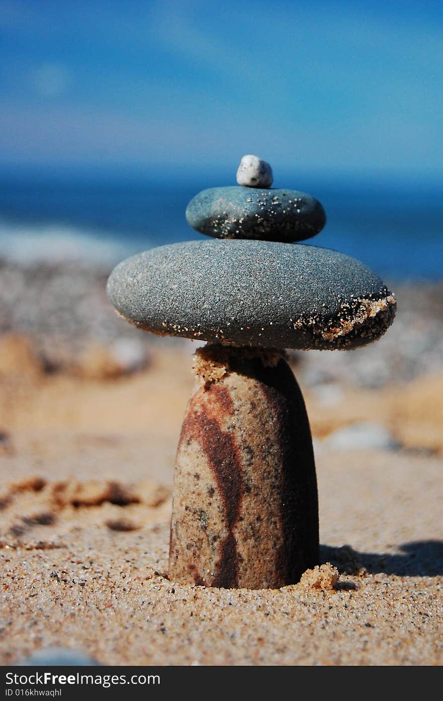 A rock dolmen on a sandy beach. A rock dolmen on a sandy beach.