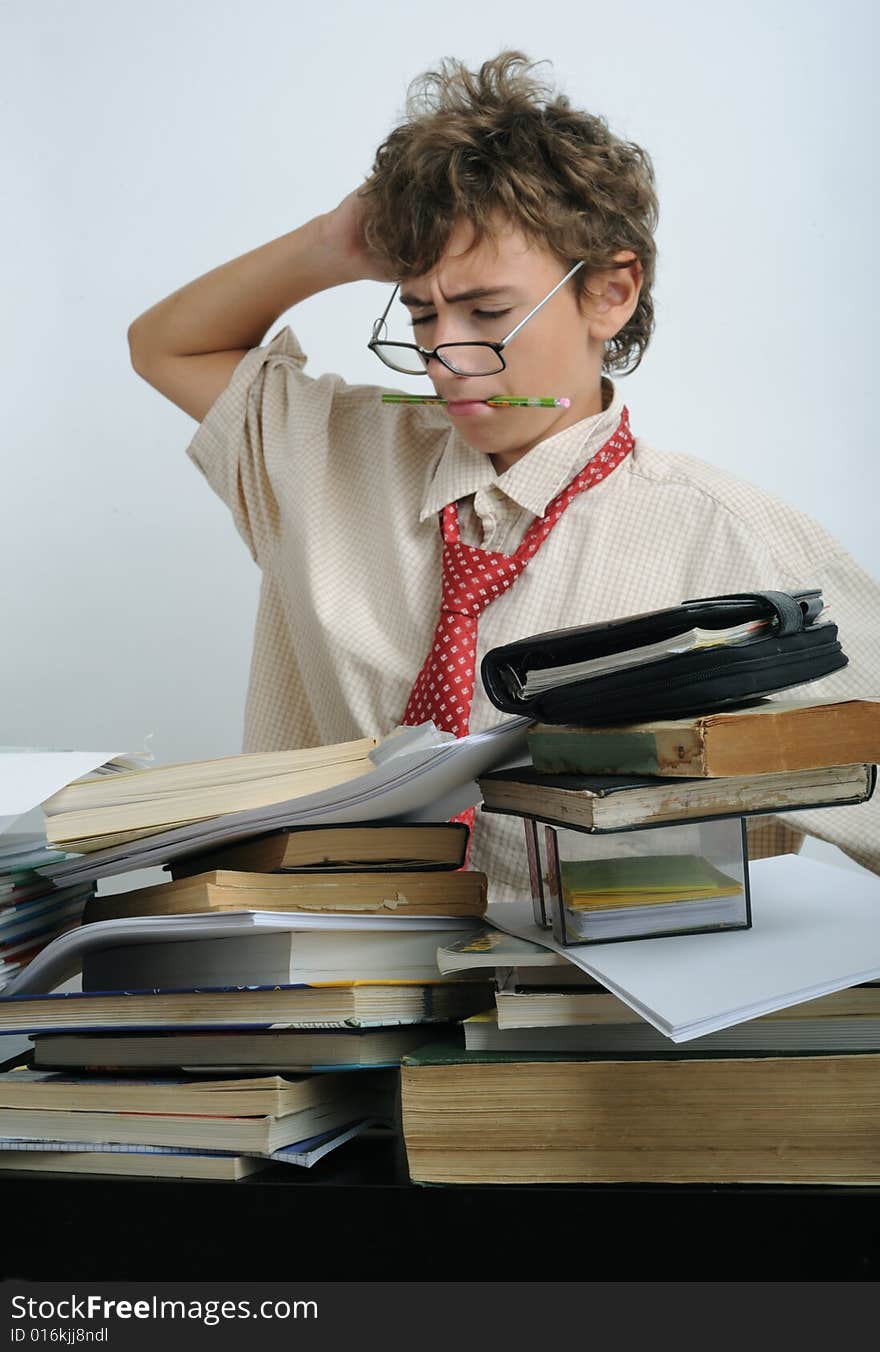 A boy behind a fully covered desk. A boy behind a fully covered desk