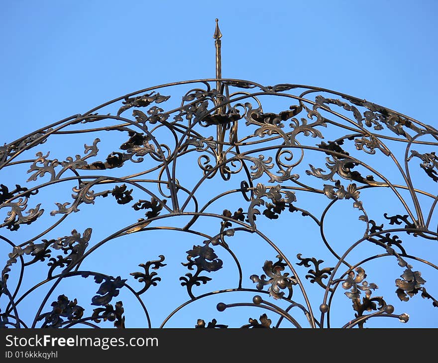 Iron Scrollwork roof on the blue background. Iron Scrollwork roof on the blue background