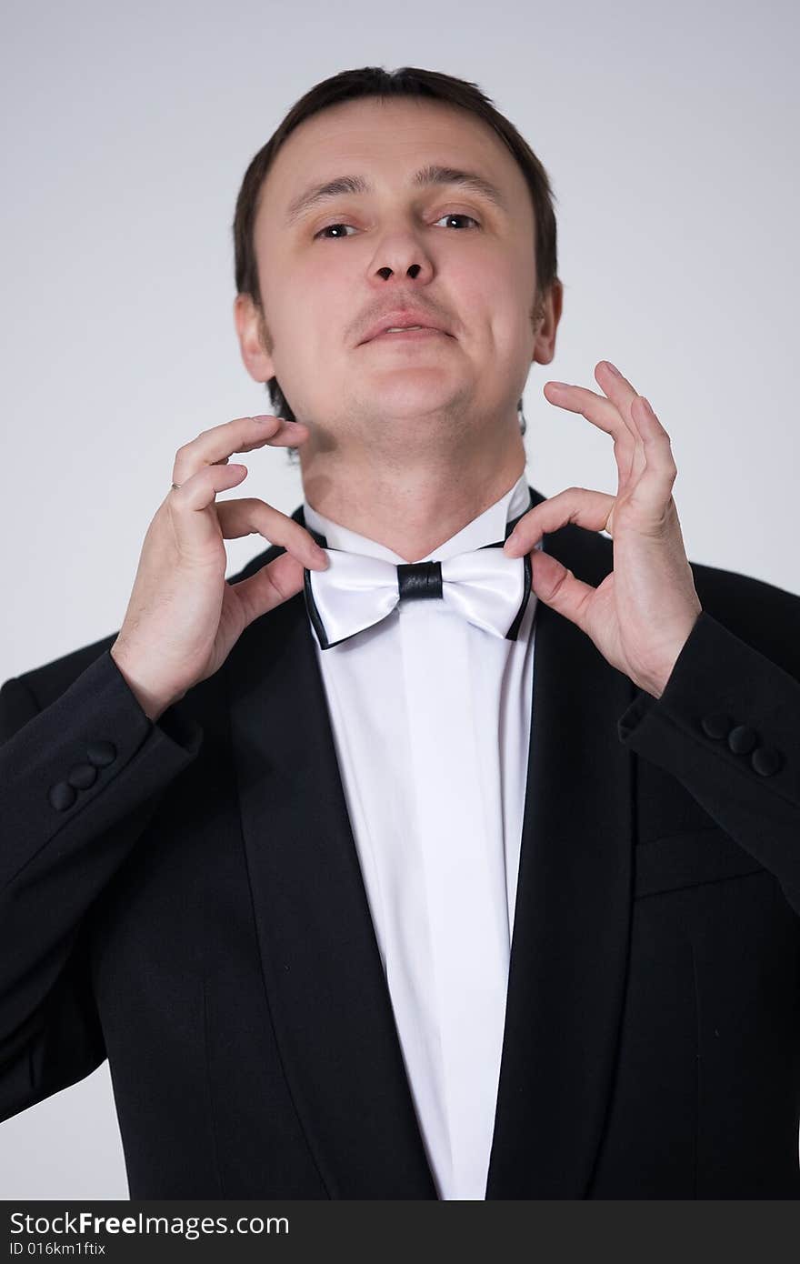 Handsome man in suit with bow-tie is smiling