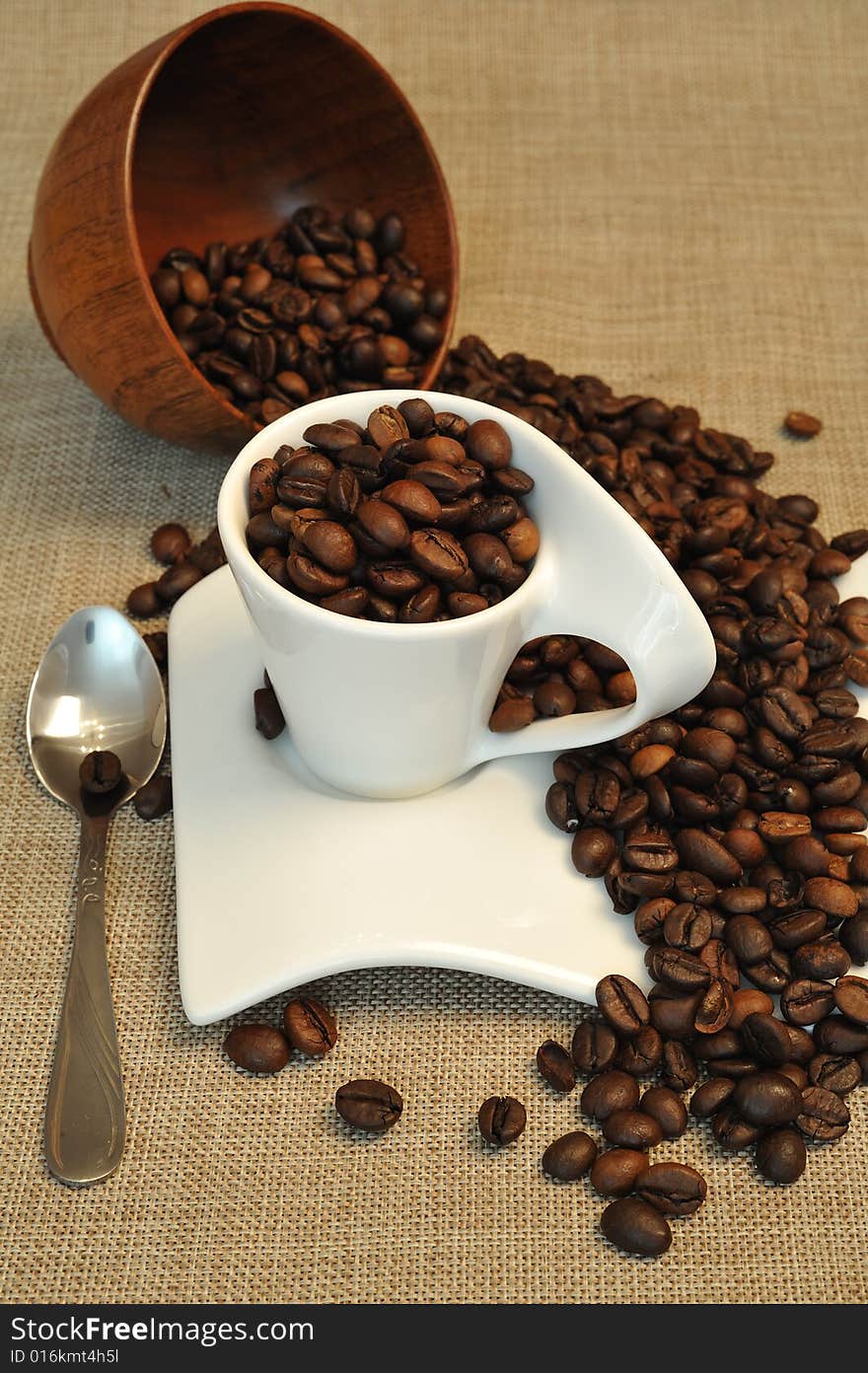 Close up of coffee beans and a white cup. Close up of coffee beans and a white cup