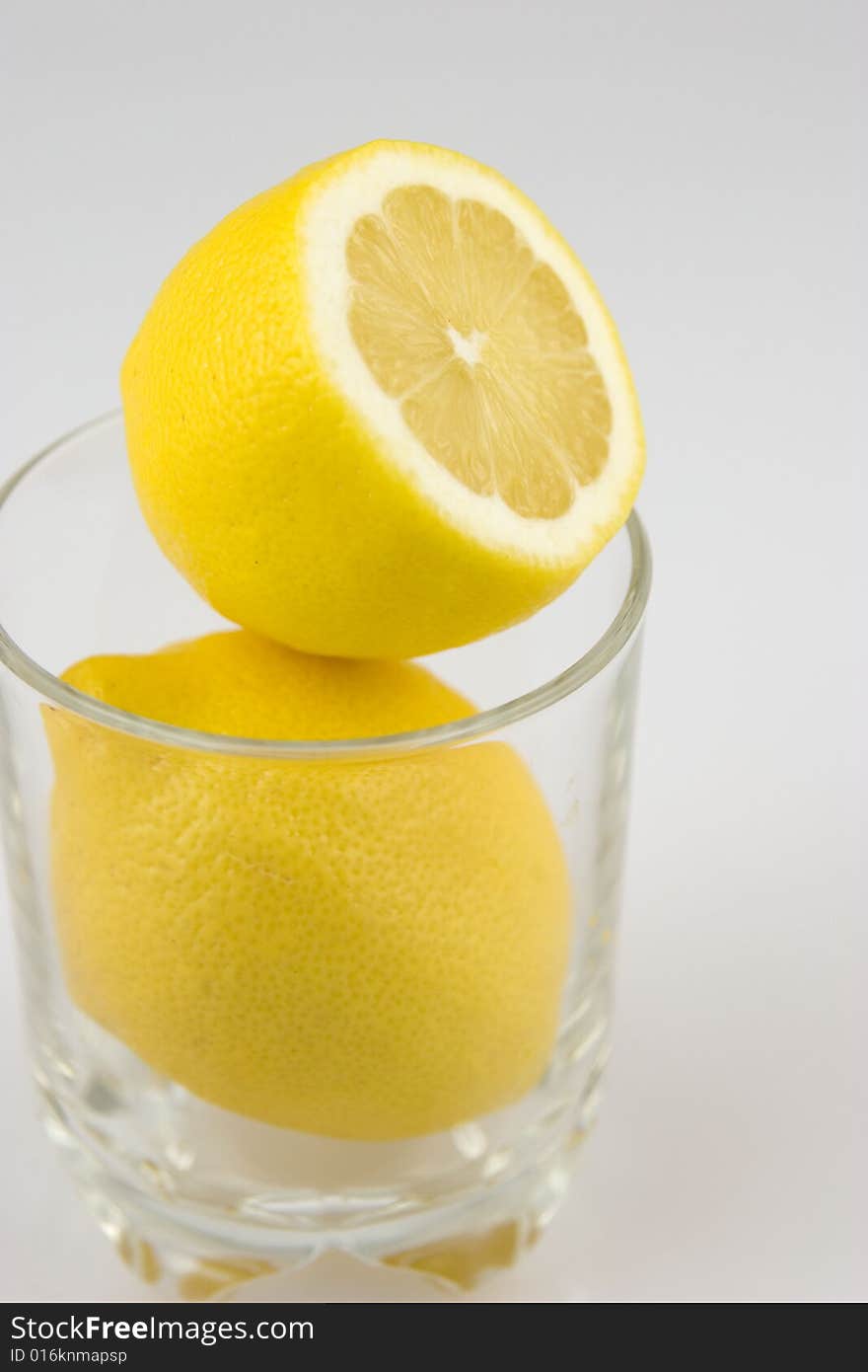 Lemons in a glass on white background