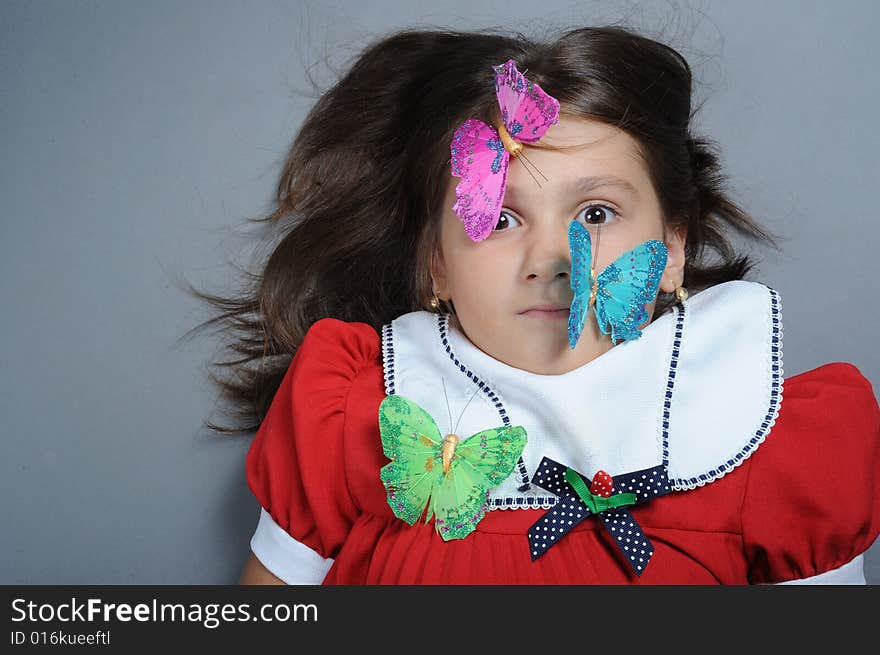 Close up portrait of a little girl with butterfly on face. Close up portrait of a little girl with butterfly on face