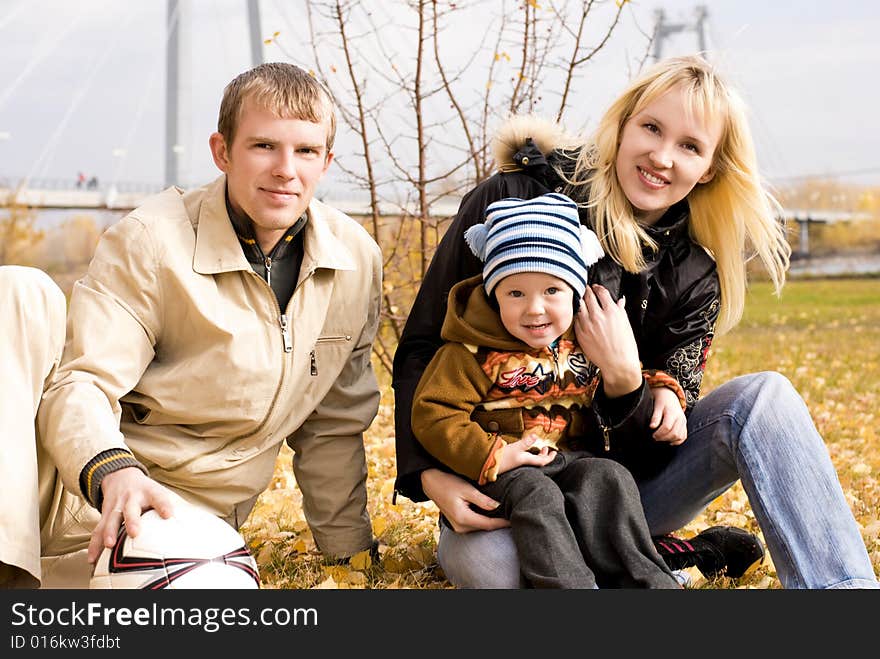 Happy smiling family with a football ball outdoor. Happy smiling family with a football ball outdoor