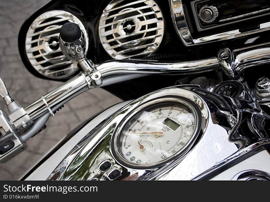 Closeup of motorcycle fuel tank with focus on speed gauge. Closeup of motorcycle fuel tank with focus on speed gauge