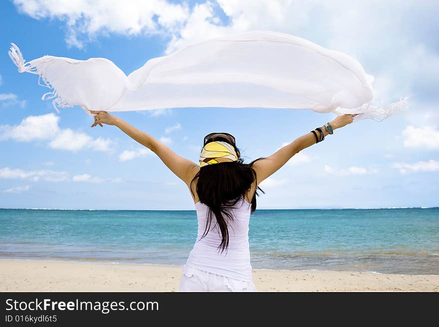 Girl with white cloth enjoying seascape