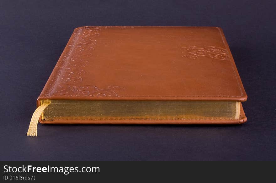 Golden book isolated on dark background