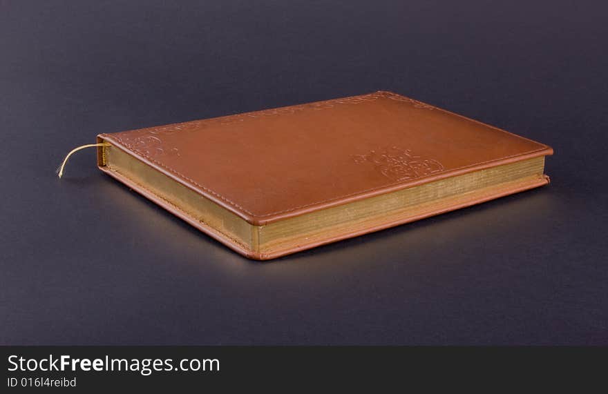 Golden book isolated on dark background