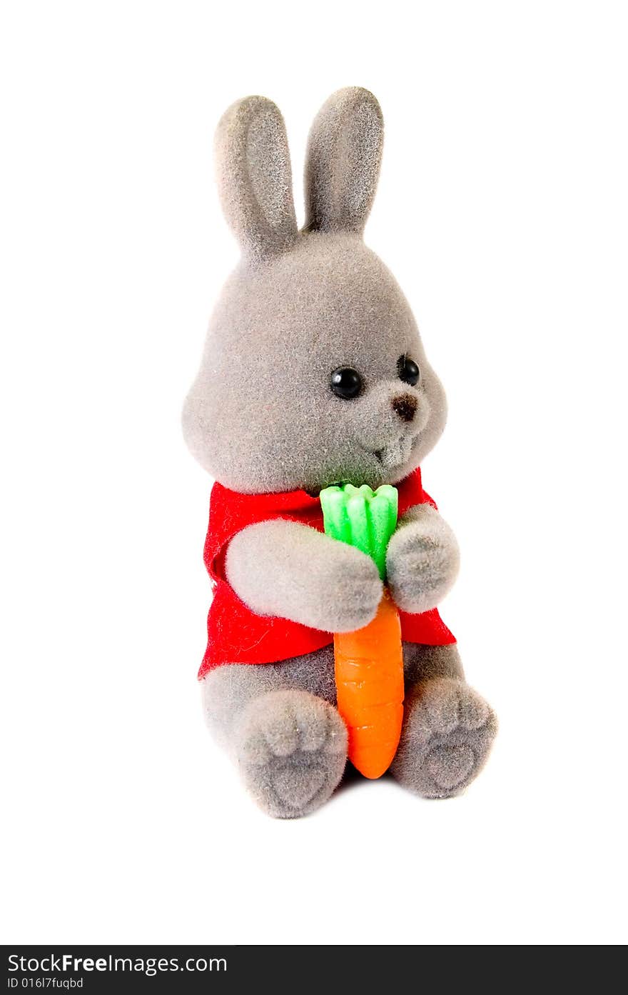 Close-up toy rabbit with carrot isolated on white