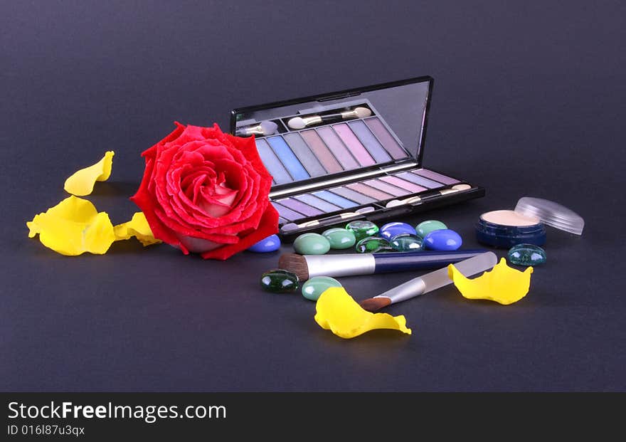 Eyeshadow and rose isolated on dark background. Eyeshadow and rose isolated on dark background