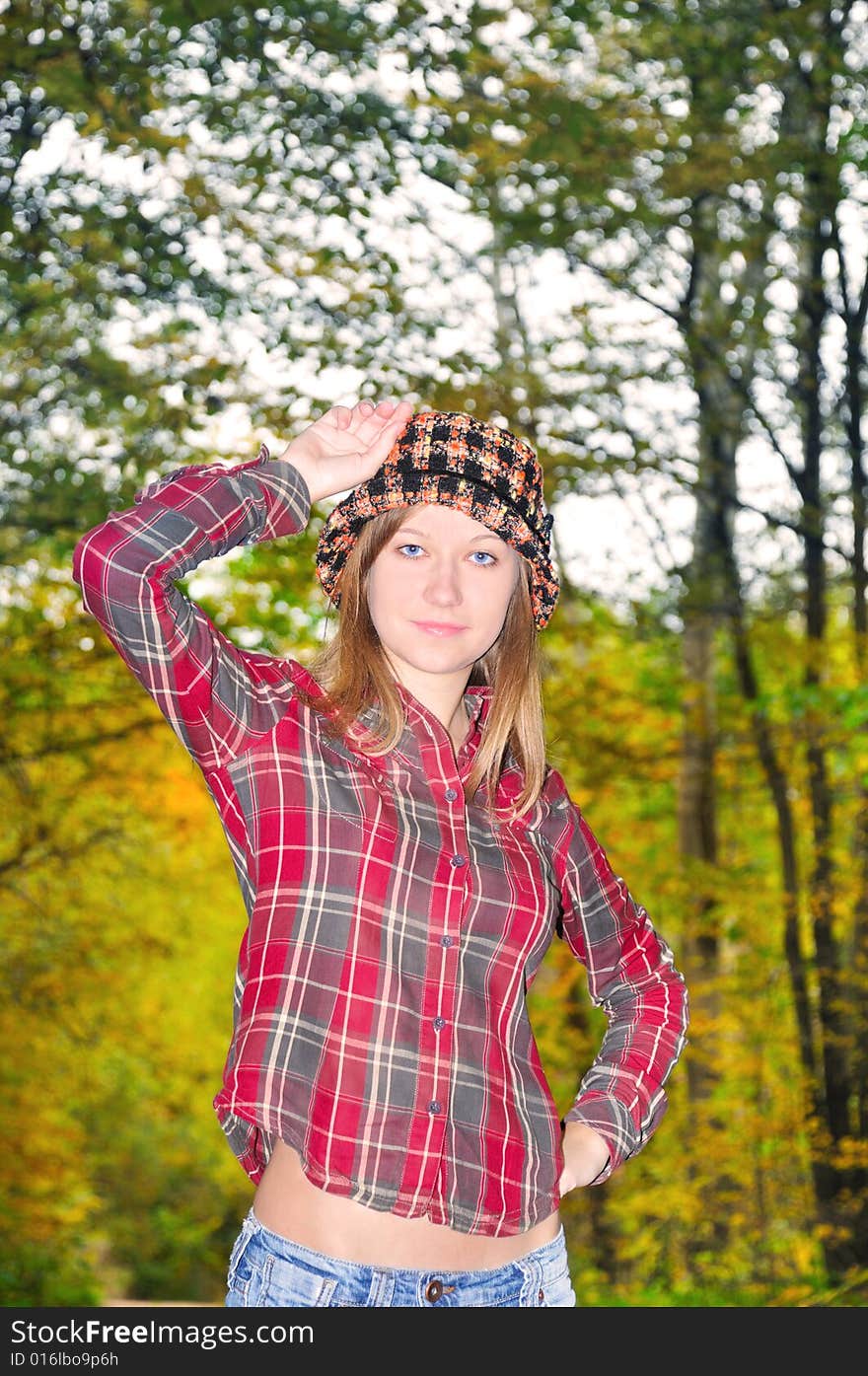 Portrait of the nice girl on autumn park background