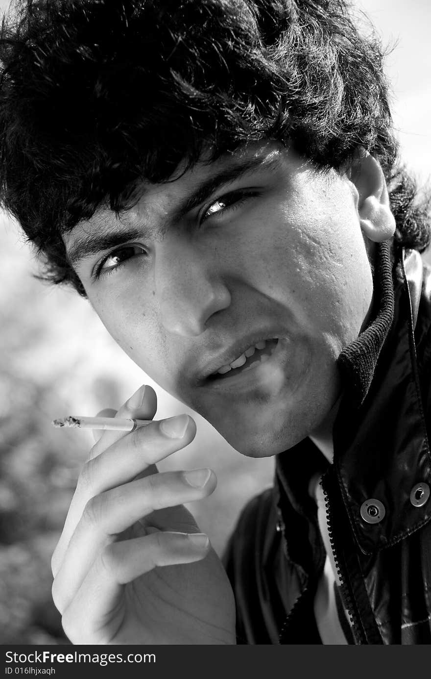 Black and white portrait of smoking arabic guy