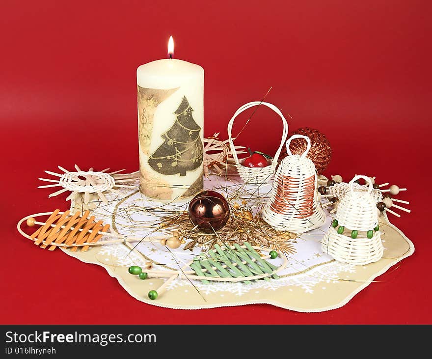 Christmas still life  with wicker decorations and candle. Christmas still life  with wicker decorations and candle