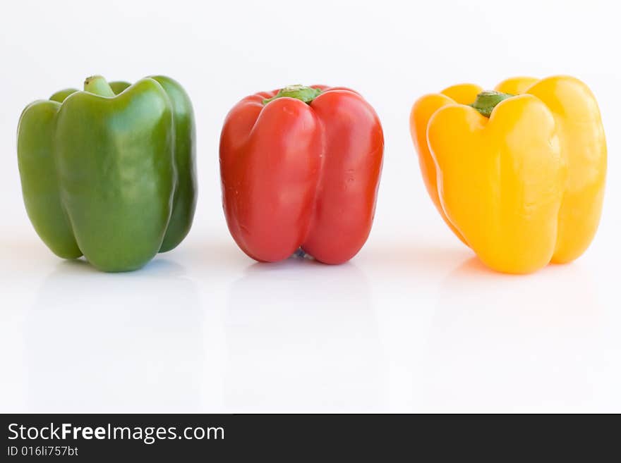 Red green and yellow pepper on white background. Red green and yellow pepper on white background