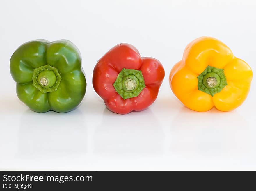 Red green and yellow pepper on white background. Red green and yellow pepper on white background