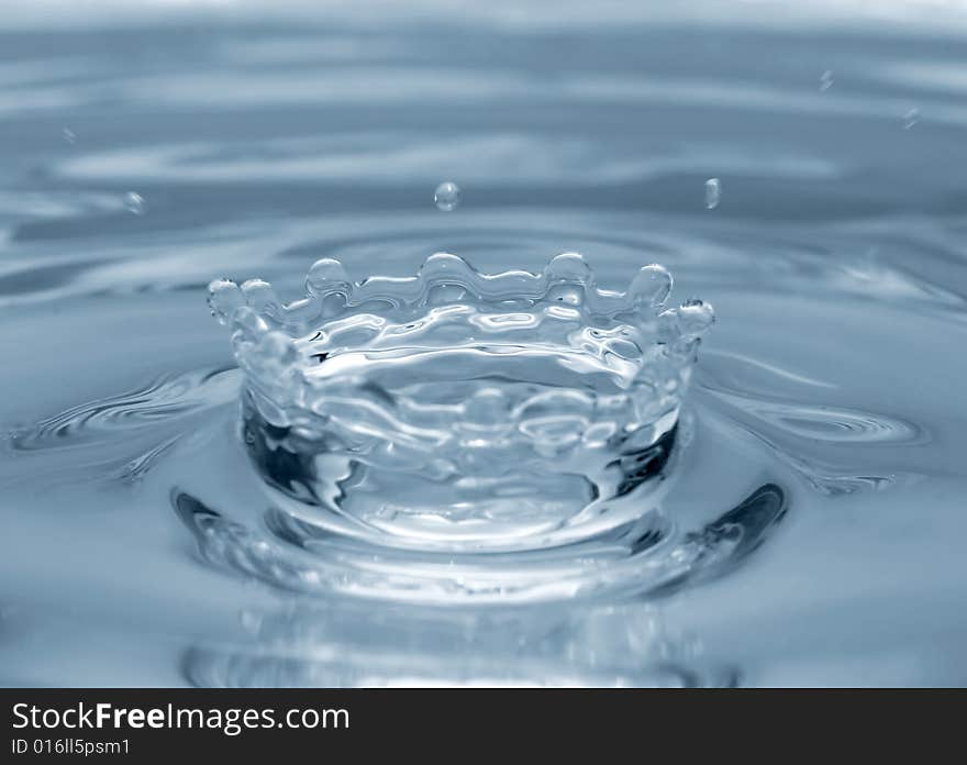 Water drop falling in water. Water drop falling in water