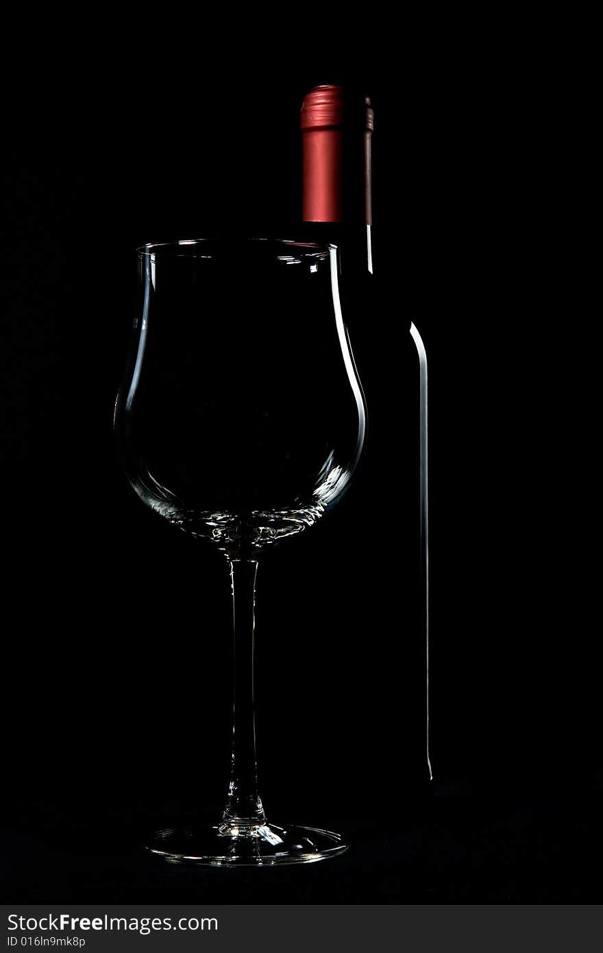 Wine bottle and glass on black backgrounds